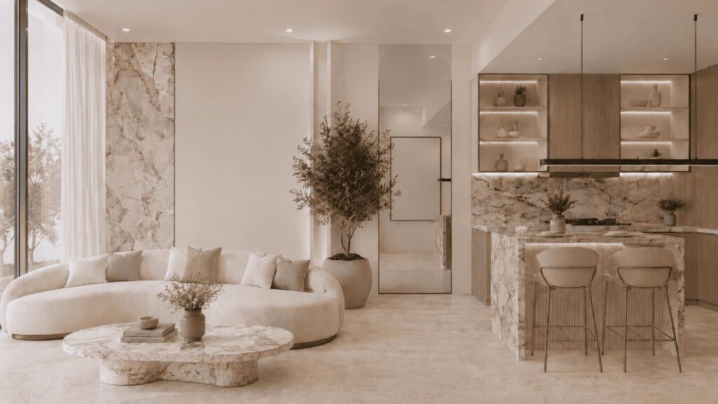 Le salon et la cuisine modernes du Beverly Crown, conçu par HMB, se distinguent par leurs plans de travail en marbre, un canapé aux lignes courbes, une table basse ronde en marbre, des étagères ouvertes, des tabourets de bar, des plantes en pot et de grandes baies vitrées laissant entrer la lumière naturelle.