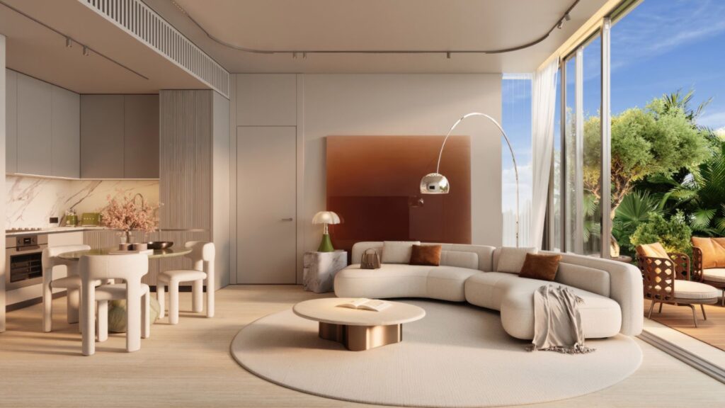 Salon moderne avec un canapé blanc aux lignes courbes, une table basse ronde, un coin repas et de grandes baies vitrées donnant sur une terrasse extérieure verdoyante. Inspiré par l'élégance du Château Piétrus, cet espace baigné de lumière naturelle, aux tons neutres et à la décoration minimaliste, se révèle lumineux et accueillant.