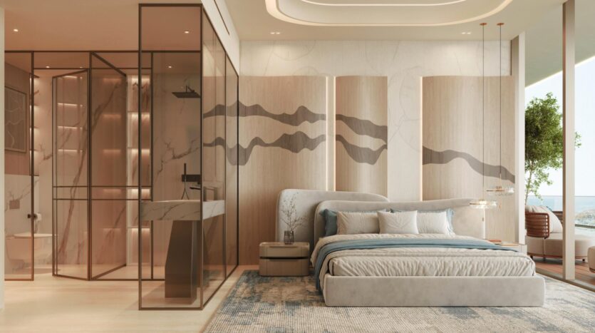 Chambre moderne dotée d'un grand lit, aux tons neutres et doux, avec des œuvres d'art abstraites aux murs, une salle de bains vitrée, de la lumière naturelle et une vue sur l'océan à travers les baies vitrées de la résidence Vue Dorée. La décoration minimaliste et les plantes apportent une touche de sérénité.