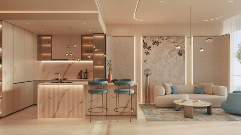 Cuisine et salon modernes, agrémentés de touches de marbre, de murs beiges, de tabourets de bar rembourrés bleus, d’un canapé incurvé, d’une table basse ronde et d’un mur d’accent à motifs floraux : cet espace inspiré de Vue Dorée se distingue par un éclairage chaleureux et une décoration élégante et minimaliste.